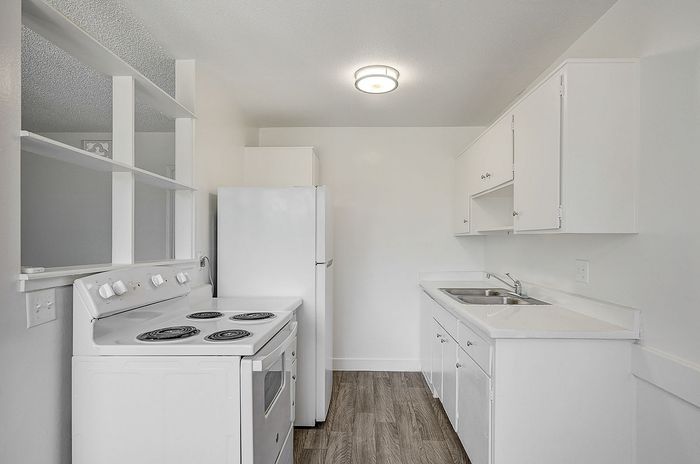Bright and modern kitchen with sleek white cabinets, stylish countertops, and an efficient layout, perfect for culinary creativity.
