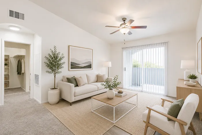 Bright and airy living room featuring modern decor, cozy seating, and a scenic balcony view.