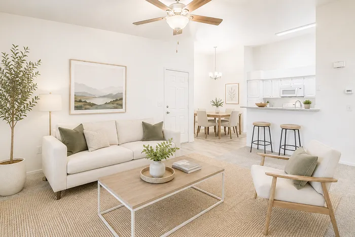 Bright and inviting living room with modern furnishings, blending seamlessly into an open kitchen-dining area, perfect for entertaining.