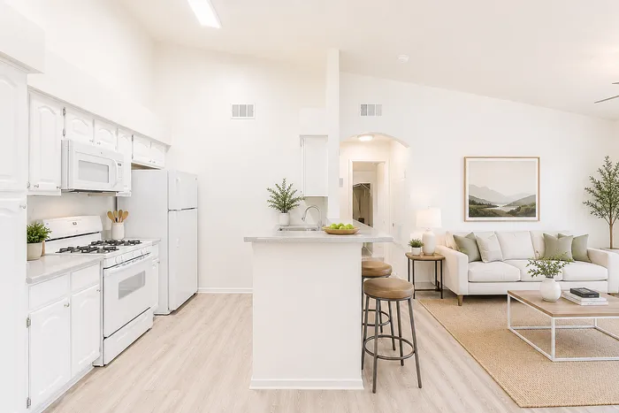 Bright and inviting open-concept living area with a sleek kitchen, cozy dining space, and elegant decor.