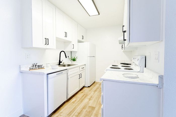 Bright and modern kitchen with sleek white cabinets, elegant countertops, and a cozy vibe.