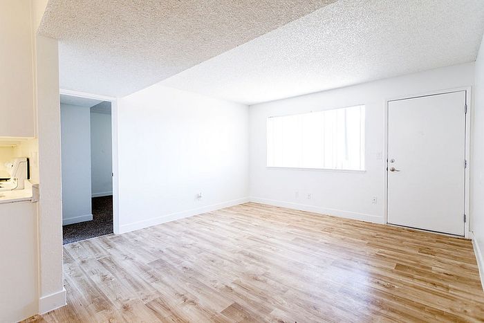 Bright and airy living space with modern wood flooring and ample natural light.
