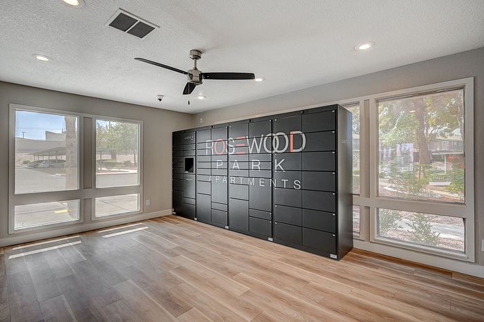 Modern apartment lobby at Rosewood Park Apartments featuring sleek black mailbox system and elegant hardwood floors.