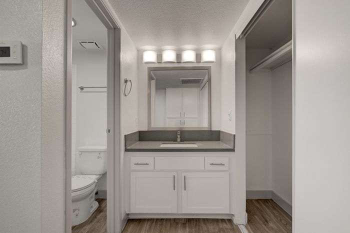 Modern bathroom with sleek vanity, warm lighting, and a minimalist design.