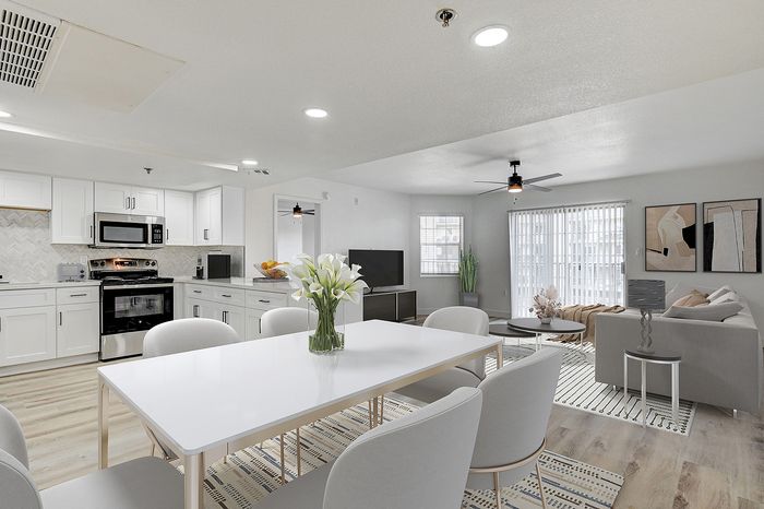 Bright and modern open-concept living space with sleek kitchen and elegant dining area, perfect for entertaining.