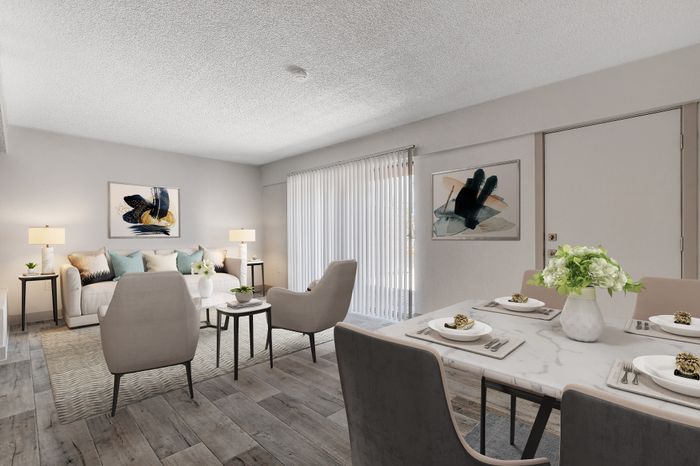 Elegant living and dining area with modern decor, featuring plush seating, abstract artwork, and a bright, airy ambiance.