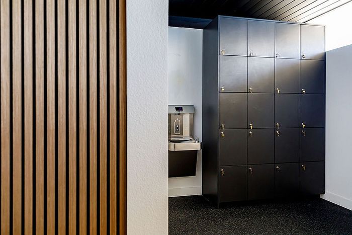Modern apartment detail with sleek black lockers and stylish wood paneling.