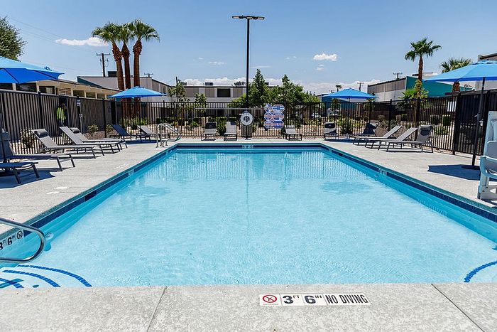 Inviting outdoor pool area with sun loungers and umbrellas, perfect for relaxation and leisure.