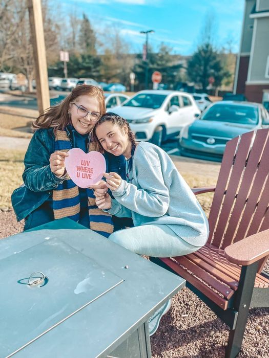 Two friends sitting on a lawn chair