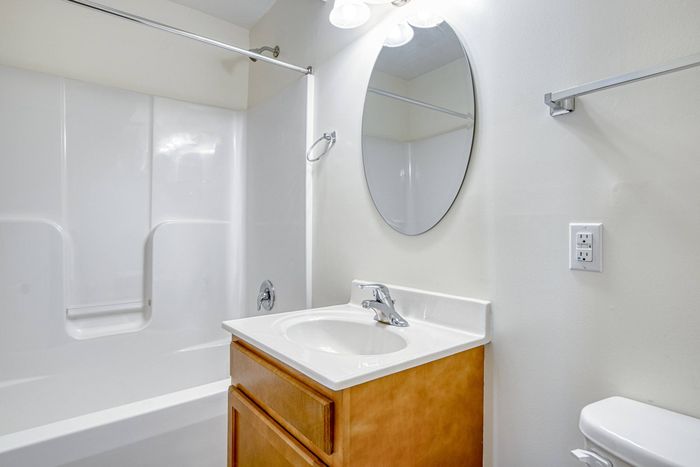 Model bathroom at our student apartments in Blacksburg, featuring granite patterned countertops and a bath / shower combo.