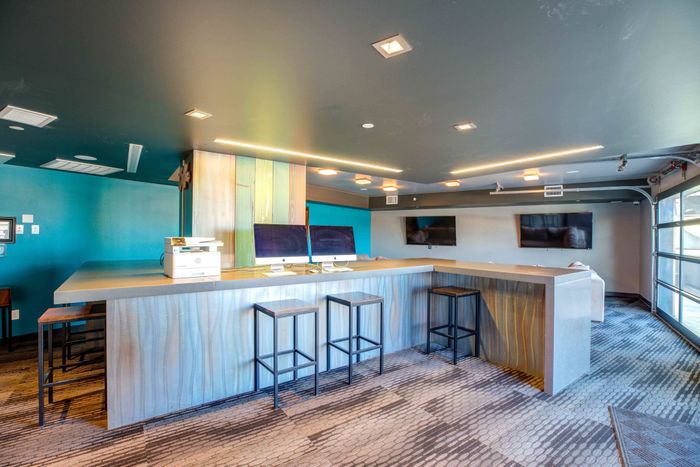 Community clubhouse with computers for students to use at Union on Alley with high bar top seating at Union on Alley.