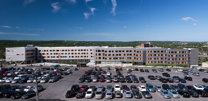 The exterior of our student apartments in Syracuse, featuring a view of the modern exterior and the streets.