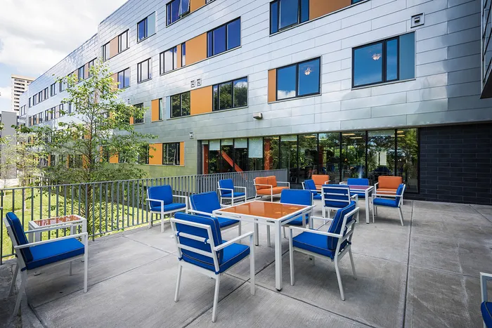 Outdoor resident lounge with ample seating areas at Campus West Syracuse student apartments.