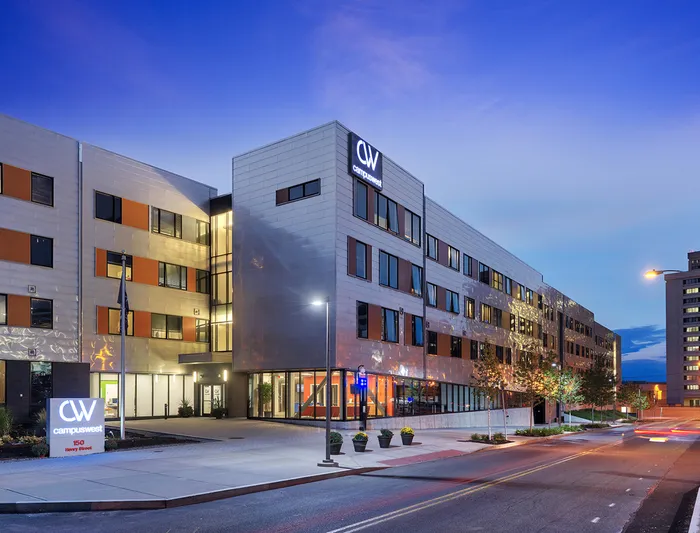 The exterior of our student apartments in Syracuse, featuring a view of the modern exterior and the streets.