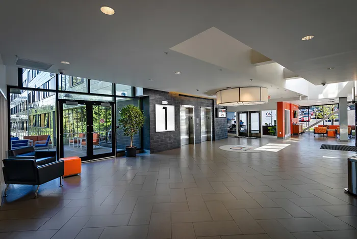 The hallway at our student housing in Syracuse, featuring tiled flooring and doors to the elevators.