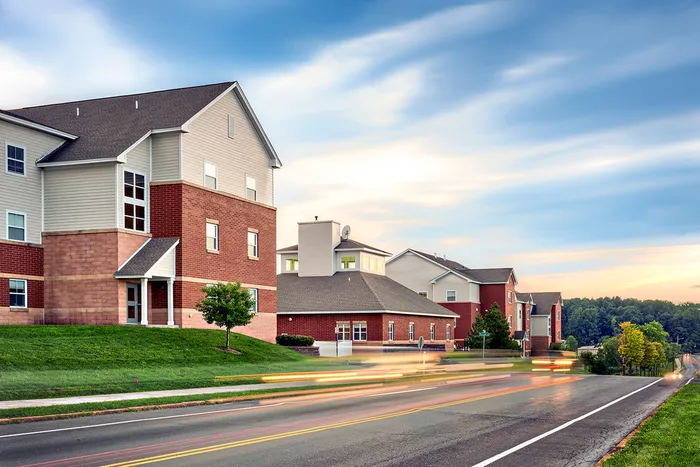 The exterior of the University Village on Colvin apartments in Syracuse, featuring a view of the brick exteriors