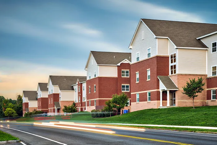 The exterior of the University Village on Colvin apartments in Syracuse, featuring a view of the brick exteriors