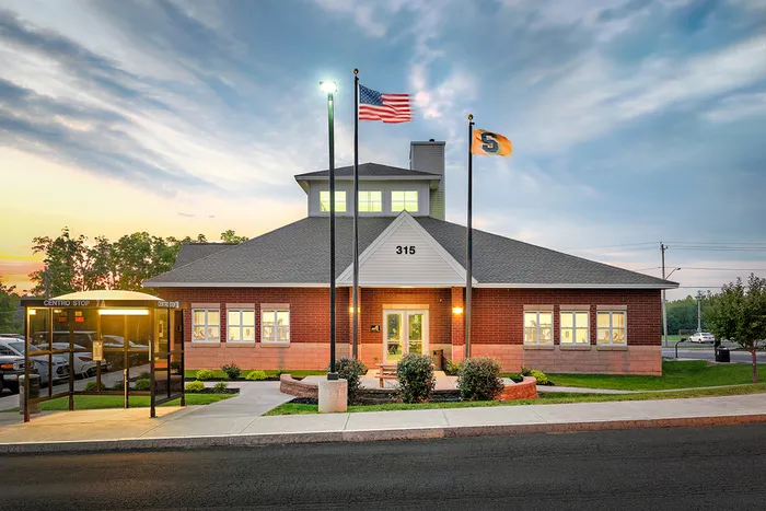 The exterior of the University Village on Colvin apartments in Syracuse, featuring a view of the brick exteriors