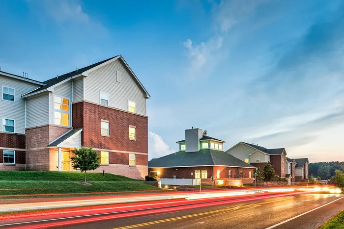 The exterior of the University Village on Colvin apartments in Syracuse, featuring a view of the brick exteriors
