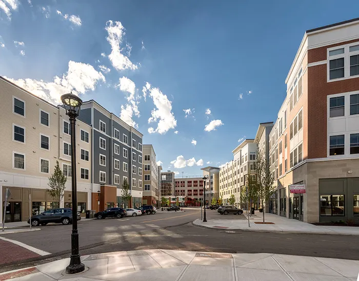 Plaza near our UConn student apartments near campus, featuring a view of a public sculpture and downtown streets.