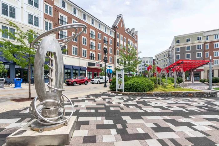 Plaza near our UConn student apartments near campus, featuring a view of a public sculpture and downtown streets.