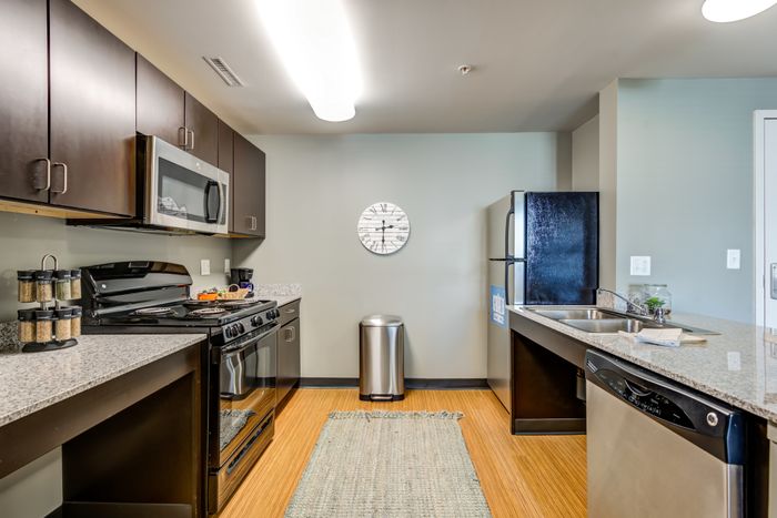 Kitchen with stainless steel appliances at Campus West apartments in Syracuse, NY.