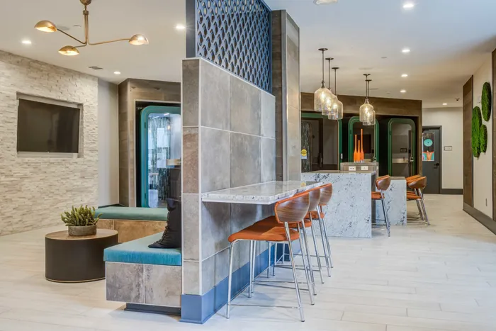 Meeting space at our apartments in Blacksburg, VA, featuring carpeted flooring and a conference table with chairs.