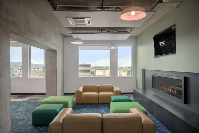 Media lounge with flat screen tv, comfortable seating, and a fireplace