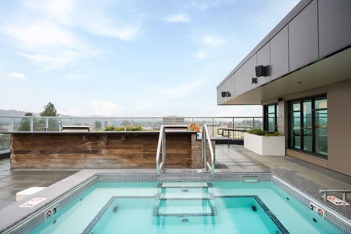 Rooftop lounge with hot tub overlooking the city of Eugene