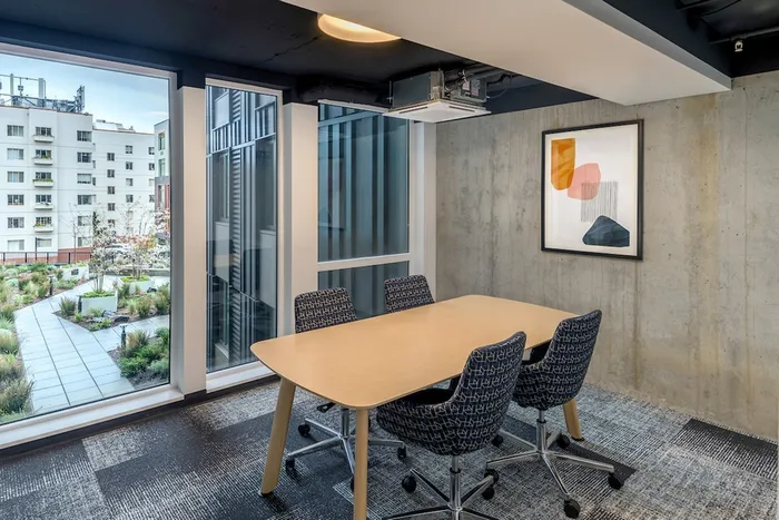 Private study lounge with large windows looking out at the greenery in the community courtyard