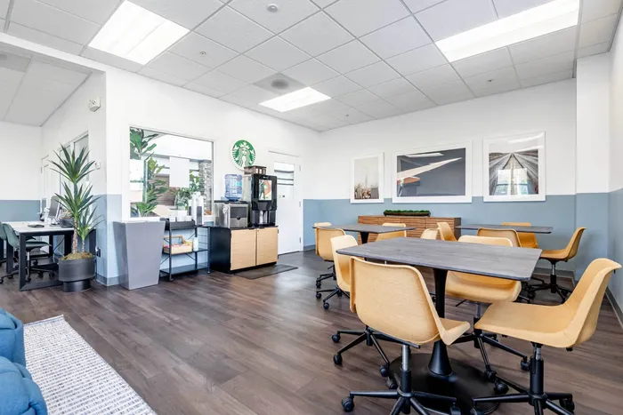 The conference room at our student apartments in Syracuse, featuring a conference table surrounded by chairs.