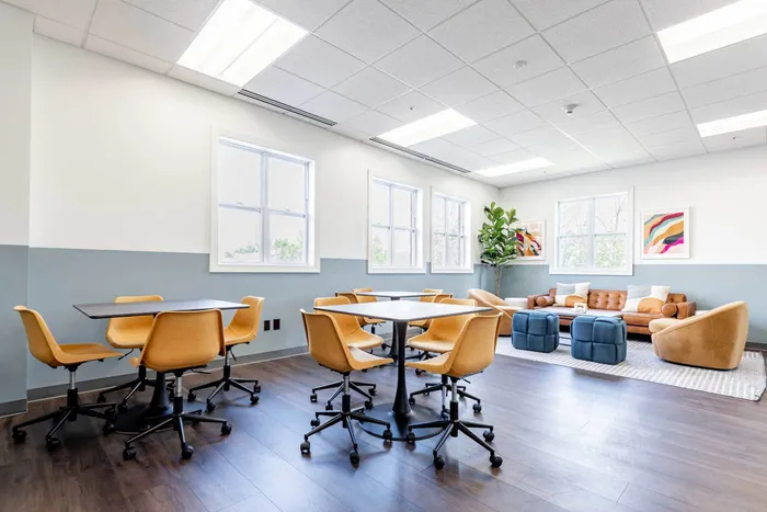The conference room at our student apartments in Syracuse, featuring a conference table surrounded by chairs.