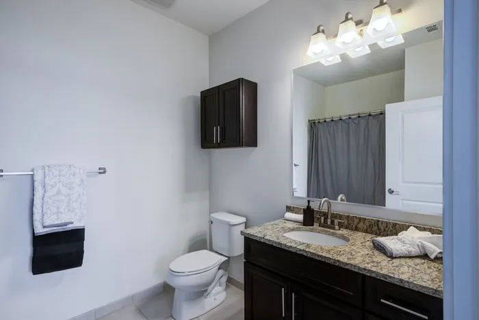 Model bathroom at our student housing in Storrs, CT, featuring tiled flooring and a shower / bath combo.