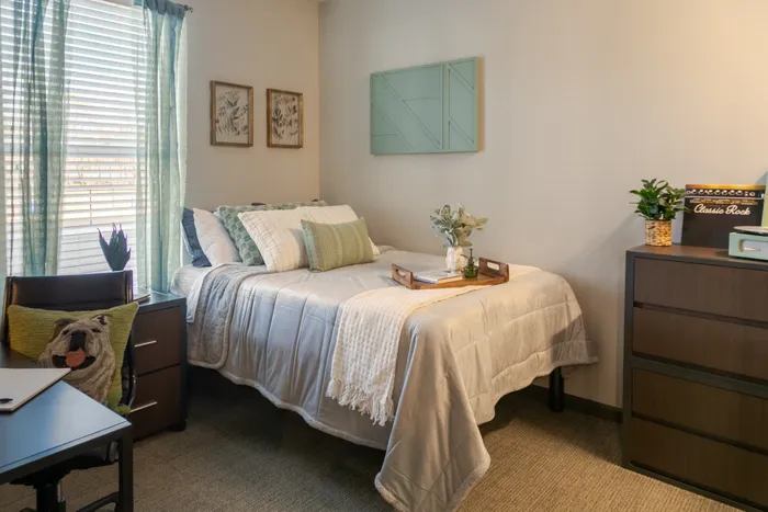 Furnished bedroom at College View Mississippi State student apartments.