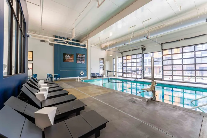 Indoor pool with loungers at our luxury apartments in Minneapolis, The Marshall.