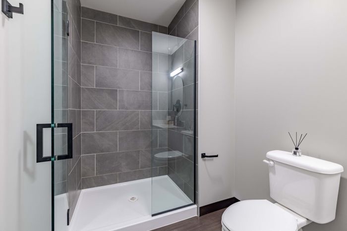 Model apartment bathroom showcasing the gray tiled shower