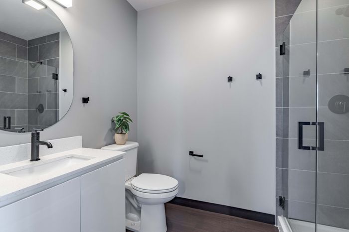 Model apartment bathroom with white fixtures
