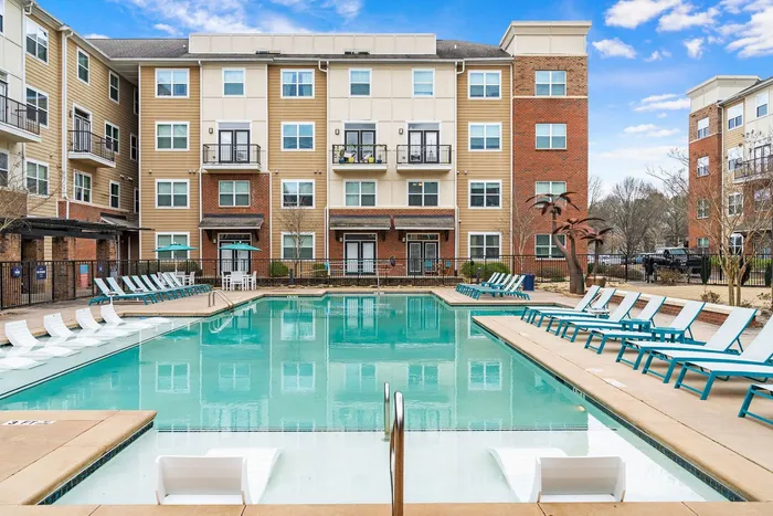 The Blake apartments in Kennesaw showcasing the pool area with lounge chairs for sunbathing.