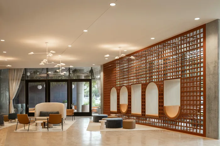 Union on 24th apartments in Austin clubhouse lounge with ample seating and large glass doors leading to outside.