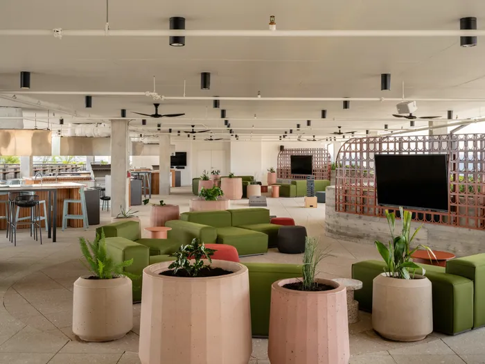 Outdoor lounge at Union on 24th apartments with comfortable seating around the flat screen TVs.