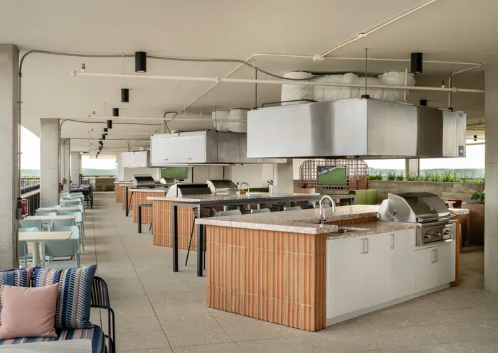 Outdoor grilling space with plenty of space to cook and entertain at Union on 24th apartments near the University of Texas.