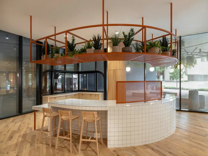 Curved tile island with high top seating in the Union on 24th clubhouse near University of Texas.
