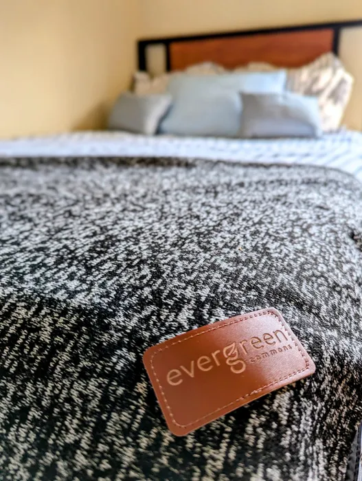 Bed with evergreen blanket