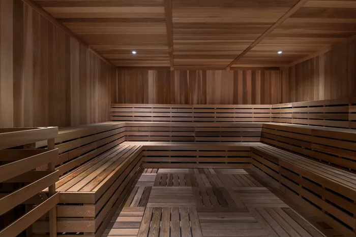 Sauna with wood floors and seating for residents to relax in