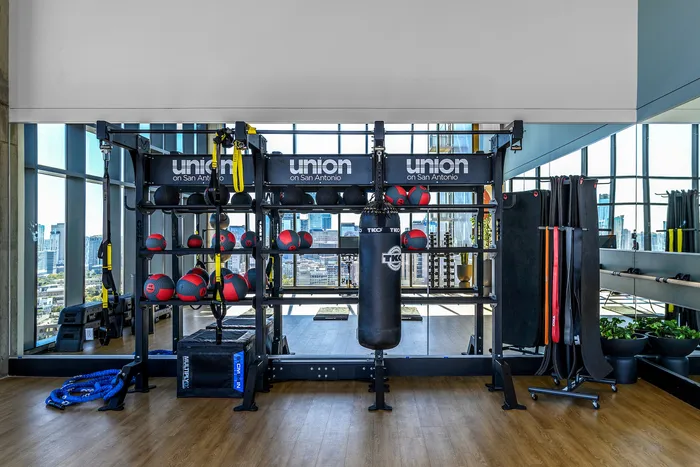 Fitness center stretching studio with medicine balls, stretching bands, and a punching bag for residents to use