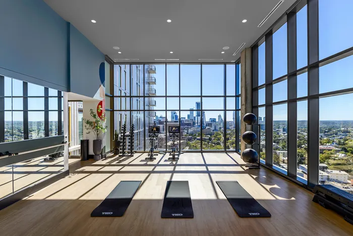 Stretching studio with yoga mats, balance balls, and cycling equipment