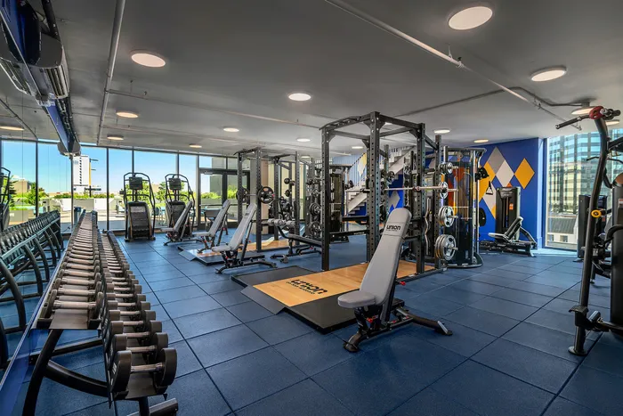 Gym with strength training equipment at Union on San Antonio, among the best apartments for UT Austin students.