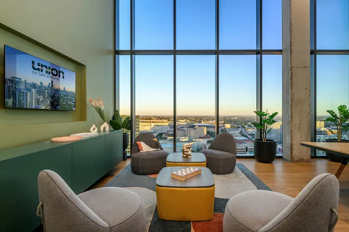 Clubhouse with comfortable seating facing a flat screen tv