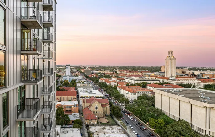 Photo of the exterior of the building with UT Austin in the background