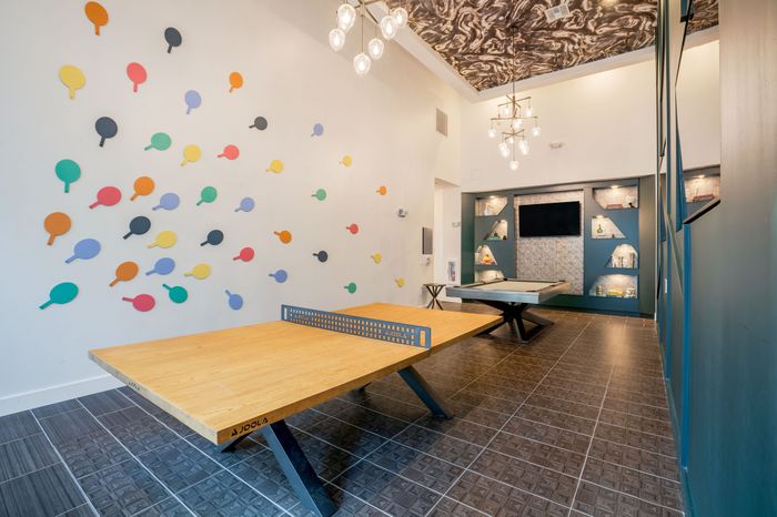 Resident game room with a ping pong table and a pool table at The Accolade Collegiate Village East apartments in Orlando, FL.